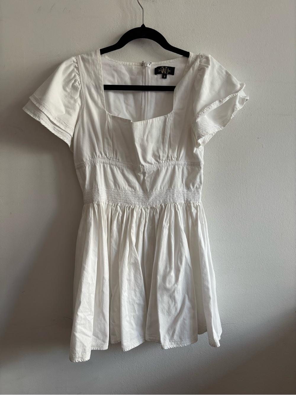 De La Vali white mini dress with ruffled sleeves and a square neckline